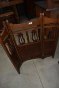 An early C20th oak 3 tier fold fire screen having lyre decoration