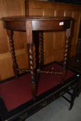 An early C20th oak occasional table having twist legs and X frame