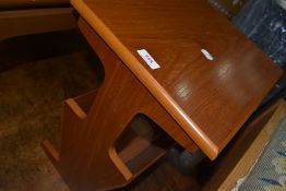A 1980's teak effect magazine rack