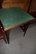 A vintage folding baize top card table