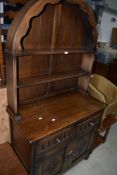 A late C20th oak reproduction Dutch style dresser with Delft rack over drawers and cupboards