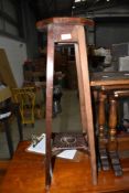 An Edwardian mahogany inlaid and carved plant stand
