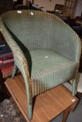 A vintage Lloyd Loom armchair in green
