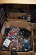 A large collection of of computer and electrical components including motherboards.