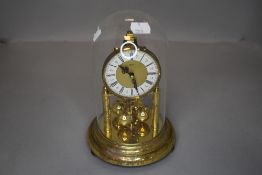 An anniversary clock having Roman numerals to face and glass dome.