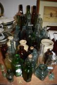 A collection of vintage glass and stoneware bottles and jars amongst which there are some of