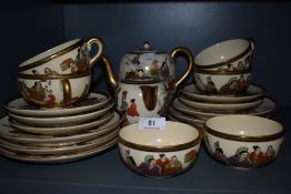 A Japanese Satsuma part tea set having hand painted scenes and gilt detailing, including tea pot,