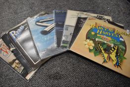 A mixed lot of vinyl LP records including Santana, Eric Clapton,John Miles, Roxy Music and more.