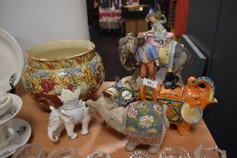 A selection of ceramics amongst which are a planter and elephant ornaments.