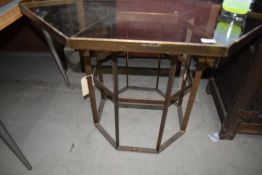 A glass top brass octagon table of geometric form, width approx 96cm