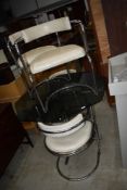A vintage chrome table and chair set, the table having octagonal glass top, the chairs having