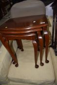 An early 20th Century mahogany nest of three tables having cabriole legs