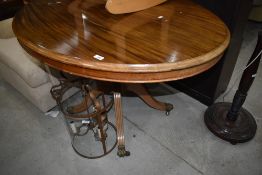 A reproduction Regency pedestal loo style table in light mahogany having oval top