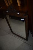 A hall way mirror having oak carved frame work