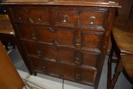 A late 19th or early 20th Century oak cushion chest in the Jacobean style, having two over three