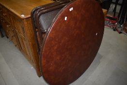 A vintage folding metal circular table and set of three similar chairs, labelled Cosco, with vinyl