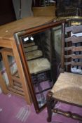 A modern mahogany effect wall mirror