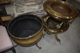 A pair of large brass urns having ball and claw feet and a large brass cauldron with lion mask