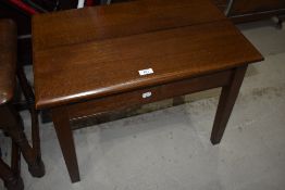 An early 20th Century dark oak low side table