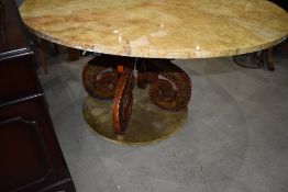 A large circular table having octopus style base with velvet lining