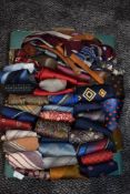 A box full of mixed vintage neckties and braces, various styles and eras.