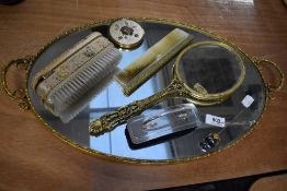 A vintage dressing table set including mirrored tray, 24kt gold plated mirror,brush with