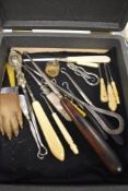 A selection of vintage glove button and dress hooks also a taxidermy otters paw
