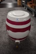 A large vintage ceramic keg with tap.