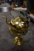 A vintage brass kettle and trivet.