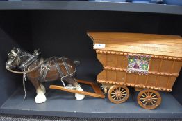 A vintage ceramic horse pulling wooden Romany caravan.