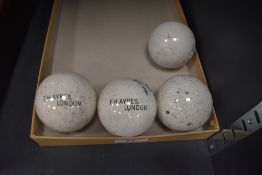 A set of four antique crown green bowling jacks by F. Hayres London