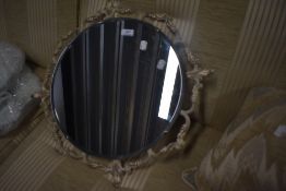 A 1950's style circular scroll frame wall mirror