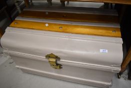 An early 20th century painted metal trunk, with later wood