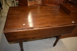 A modern dark stained extending dining table having turned legs and four additional leaves