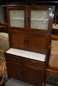 A vintage kitchenette, labelled 'neatette' frost glass top section over double cupboard, counter
