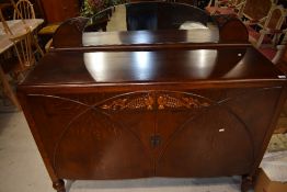 An early 20th Century oak sideboard having low mirror ledge back, width approx. 135cm