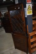 A Priory style corner display with cupboard under