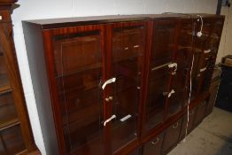 Three modern mahogany effect wall displays with illuminating interior and cupboard bases