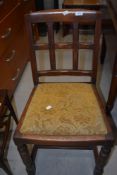 A pair of early to mid 20th Century oak dining chairs