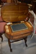 A 19th Century inlaid workbox having desk interior in typical turned frame