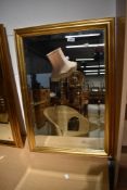 A modern gilt frame wall mirror