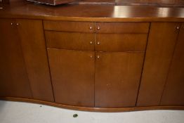 A Scandinavian laminate serpentine front sideboard, labelled Skovby, width 201cm