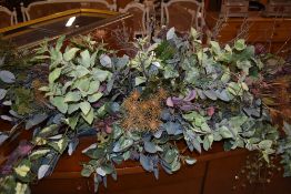 An artificial flower/plant arrangement