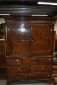 A period oak linen press having cupboard to top, and three over two over one drawer base, with