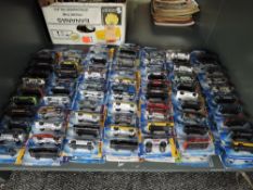 A shelf containing 140 Mattel Hot Wheels diecasts all in blister card packs including 2008 40 year