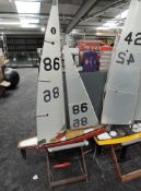 A wooden model Yacht with sail numbered 86 on wooden stand, height 170cm