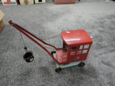 A Triang tin plate crane in red with blue chassis and black bucket