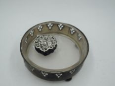A silver trinket dish having pierced decoration, bun feet and clear glass liner, Birmingham 1914,