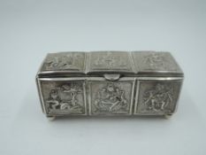 An Indian white metal lidded box having panels depicting various Hindu Deities