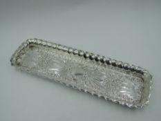 An Edwardian silver dressing table pin tray having frilled rim, plain cartouche and extensive